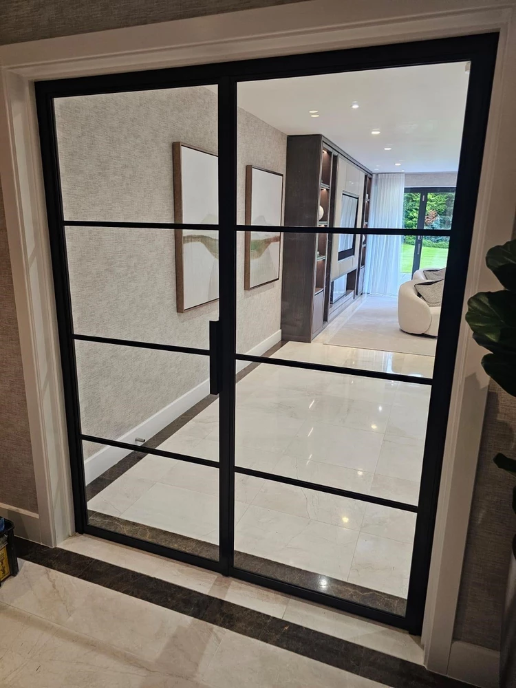 house lobby featuring black steel doors and a glossy floor