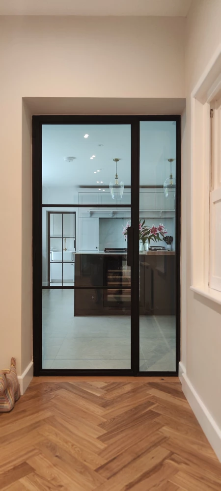 modern kitchen with crittall bifold doors and a marble countertop