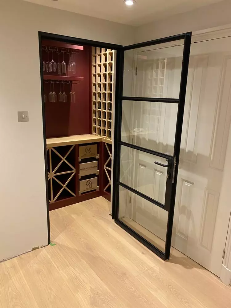 wine cellar entrance with metal doors and windows in a crittall style